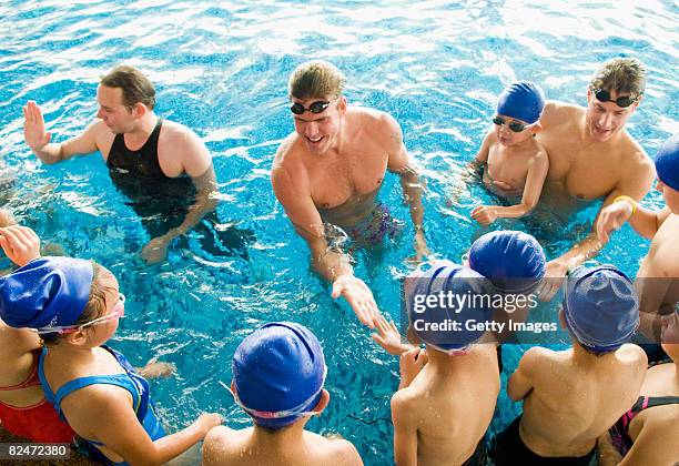 James Hickman, Gary Hall, Jr. And Ben Wildman-Tobriner instruct local Beijing children at the Speedo Stars of Tomorrow swimming clinic in the Ozone...