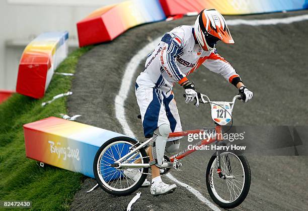 Raymon van der Biezen of the Netherlands gets up after a crash in the Men's Quarterfinals phase of the BMX competition at the Laoshan Bicycle Moto...