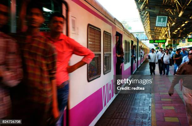 people travelling on local indian train into mumbai - overloaded passenger trains in india stock pictures, royalty-free photos & images