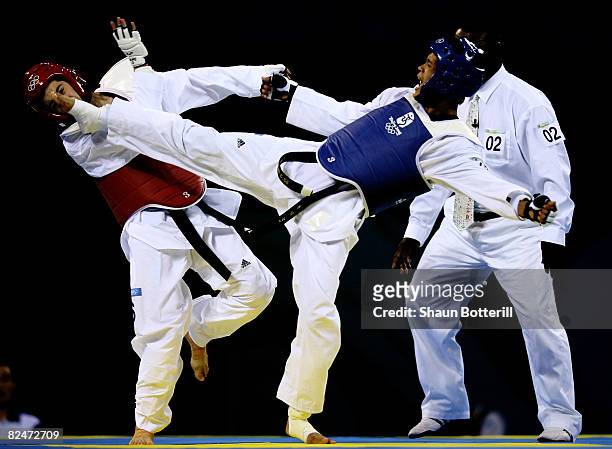 Ryan Carneli of Australia bouts with Tshomlee Go of Philippines in the taekwondo Men's 58kg Preliminary Round at the University of Science and...