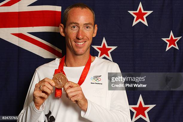 Bronze medal winner Bevan Docherty poses with his medal during a New Zealand team press conference held in the Media Press Centre on day 12 of the...