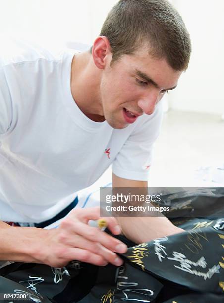 Michael Phelps signs the LZR racing suit at the Speedo Sports Club at the Jintai Art Museum on August 19, 2008 in Beijing, China.