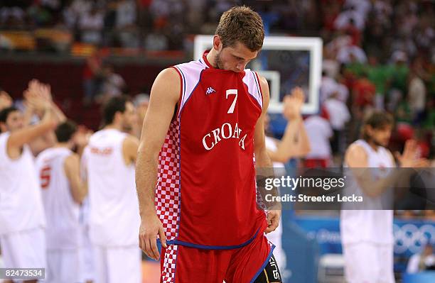 Marin Rozic of Croatia walks off the court after Spain won the men's basketball quarterfinal game 72-59 at the Olympic Basketball Gymnasium during...