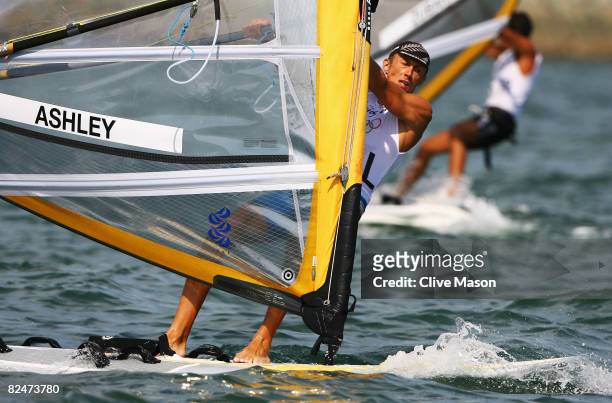 Tom Ashley of New Zealand competes on his way to finishing first placed overall in the Men's RS:X class event held at the Qingdao Olympic Sailing...