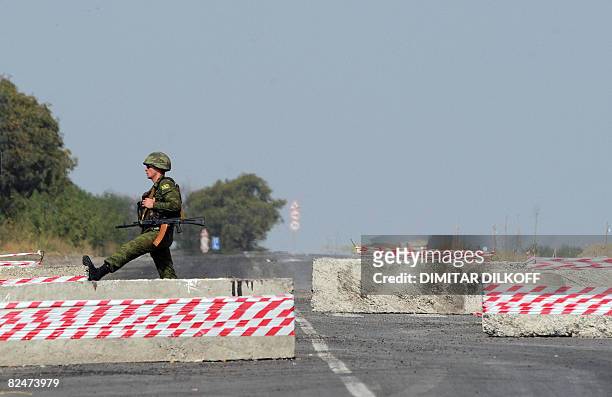 Russian soldier guards at a checkpoint on the Gori-Tbilisi road near the village of Khurvaleti on August 20, 2008. The speaker of Russia's upper...