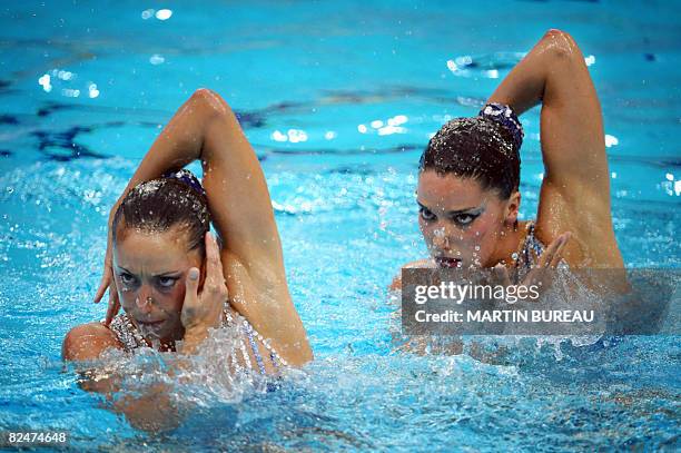 Spain's Andrea Fuentes and Gemma Mengual perform in the synchronized swimming duet free routine final event at the National Aquatics Center during...