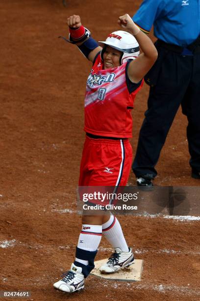 Megu Hirose of Japan celebrates as she crosses home plate and scores on her 2-run home run in the fourth inning against Australia during the women's...