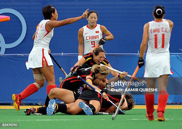 Players of Germany's celebrate after scoring a goal against China during a women's field hocker semifinal match at the 2008 Beijing Olympic Games on...