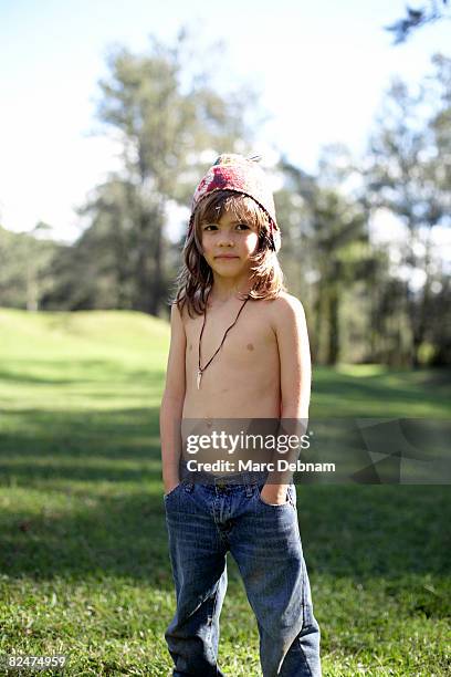 boy with hands in his pockets standing outside - boy with long hair stock pictures, royalty-free photos & images