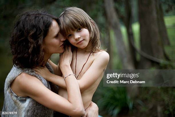 woman whispering into ear of child - semi dress stock pictures, royalty-free photos & images