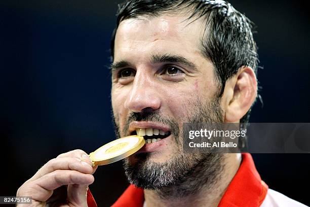 Buvaysa Saytiev of Russia celebrates his gold medal in the 74kg Men's Freestyle wrestling event at the China Agriculture University Gymnasium during...