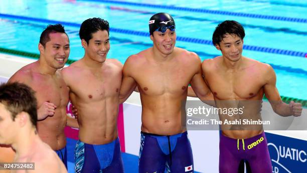 Shinri Shioura, Yuki Kobori, Yasuhiro Koseki and Ryosuke Irie of Japan pose for photographs after competing in the Men's 4x100m Medley Relay final on...