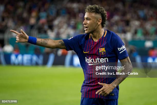 Neymar of Barcelona points to teammate Gerard Pique of Barcelona to celebrate the goal during the International Champions Cup El Clásico match...