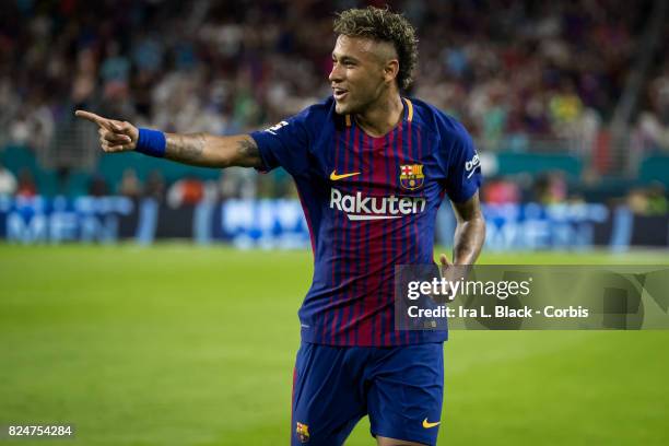 Neymar of Barcelona points to teammate Gerard Pique of Barcelona to celebrate the goal during the International Champions Cup El Clásico match...