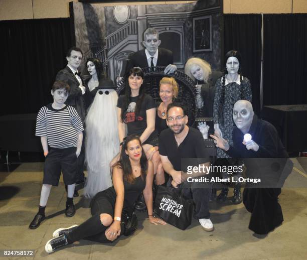 Leslie Gladney, Axelle Carolyn and Mike Mendez pose with the Addams Family on Day Two of Midsummer Scream Halloween Festival held at Long Beach...