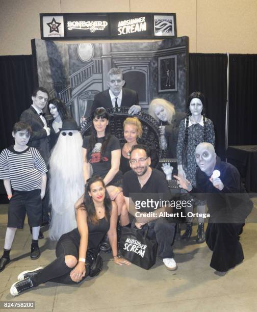 Leslie Gladney, Axelle Carolyn and Mike Mendez pose with the Addams Family on Day Two of Midsummer Scream Halloween Festival held at Long Beach...