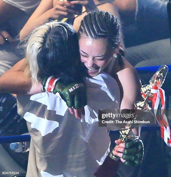 Shinju Nozawa Auclair of Japan celebrates winning the RIZIN 57.0kg Woman MMA Rules bout against Sheena Star of the United States with her mother...