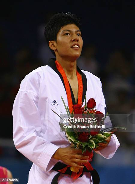 Bronze medalist Rohullah Nikpai of Afghanistan poses on the podium during the presentation ceremony of the taekwondo Men's -58kg at the University of...