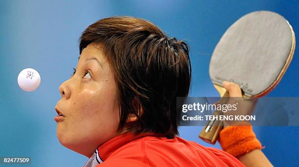 Singapore's table tennis player Wang Yue Gu plays against Dominican Republic's Wu Xue in their Women's singles table tennis preliminary round match...