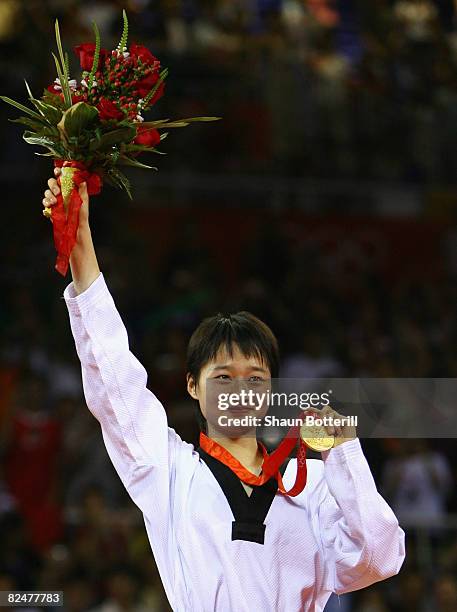 Gold medalist Wu Jingyu of China poses on the podium after the presentation ceremony for the Women's taekwondo -49kg at the University of Science and...