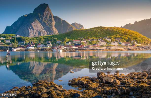 norwegian fishing village  at the lofoten islands in norway. dramatic sunset clouds moving over steep mountain peaks. - 4k resolution stock pictures, royalty-free photos & images