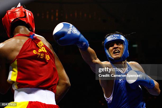 Vijender Kumar of India fights Carlos Gongora of Ecuador in the Men's Middle Quarterfinal boxing event at the Workers' Gymnasium during Day 12 of the...