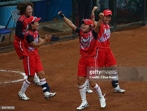 Eri Yamada and Rei Nishiyama of Japan celebrate a 2-run hit by teammate Megu Hirose in the bottom of the fourth inning against Australia in the...