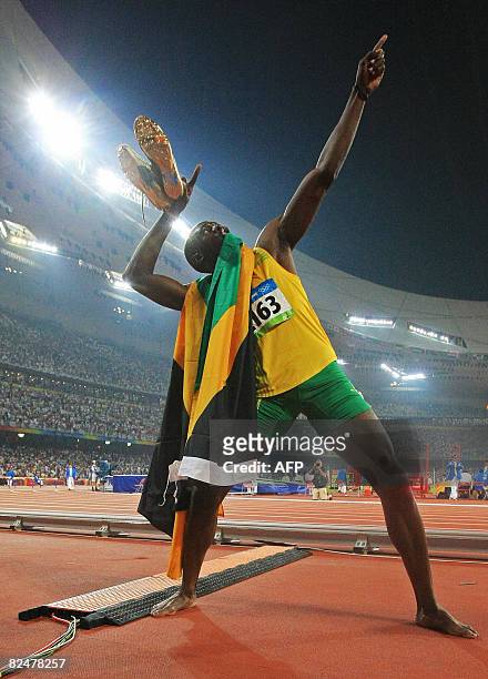 Jamaica's Usain Bolt celebrates winning the men's 200m final at the "Bird's Nest" National Stadium during the 2008 Beijing Olympic Games on August...