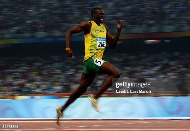 Usain Bolt of Jamaica competes on his way to breaking the world record with a time of 19.30 seconds to win the gold medal in the Men's 200m Final at...