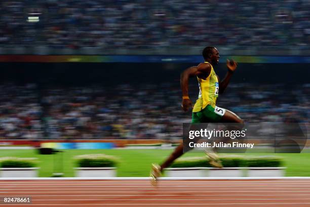 Usain Bolt of Jamaica competes on his way to breaking the world record with a time of 19.30 to win the gold medal in the Men's 200m Final at the...