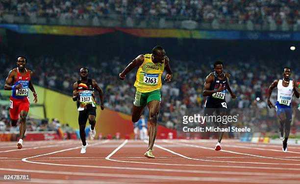 Usain Bolt of Jamaica competes on his way to breaking the world record with a time of 19.30 to win the gold medal in the Men's 200m Final against Kim...
