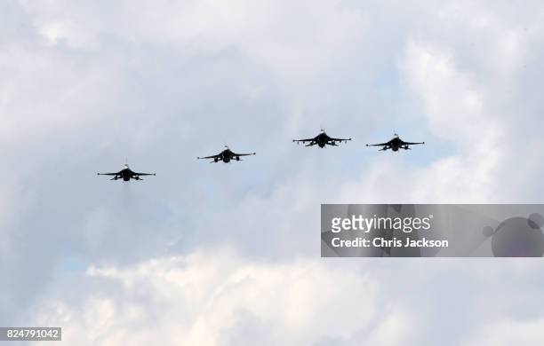 General view of a fly past by the Belgian Air Force, who flew in a formation known as "The Salute to the Missing Man" during a ceremony at the...