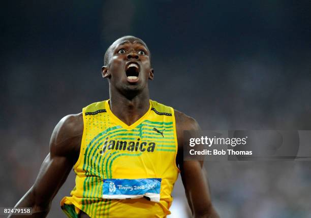 Usain Bolt of Jamaica celebrates after breaking the world record with a time of 19.30 seconds to win the gold medal in the Men's 200m Final at the...