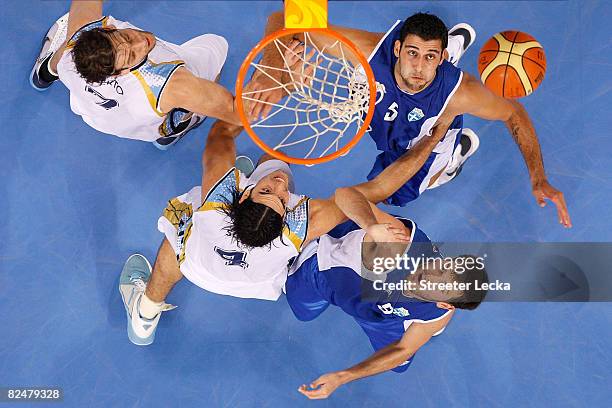 Luis Alberto Scola and Fabricio Raul Jesus Oberto of Argentina battle Ioannis Bourousis and Antonios Fotsis of Greece for possession of the ball...