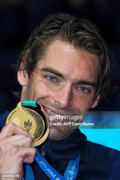 France's Camille Lacourt poses with his gold medal on the podium of the men's 50m backstroke during the swimming competition at the 2017 FINA World...