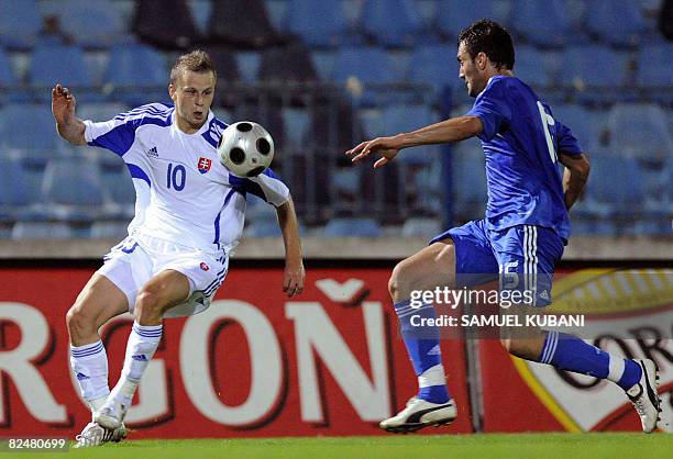 Marek Sapara of Slovakia fights for a ball with Vassilis Torosidis of Greece during their friendly football match on August 20, 2008 in Bratislava....