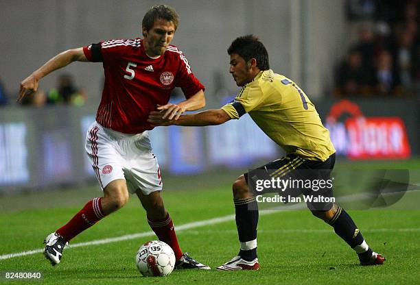 David Villa Sanchez of Spain tries to tackle Michael Silberbauer of Denmark during the International Friendly match between Denmark and Spain on...