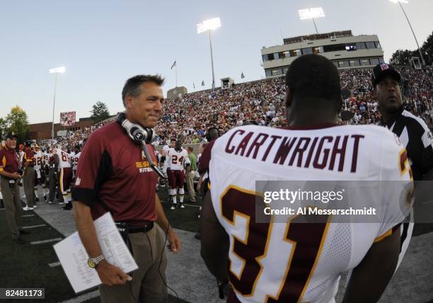 Coach Jim Zorn of the Washington Redskins waits for play against the Indianapolis Colts in the Pro Football Hall of Fame Game at Fawcett Stadium on...