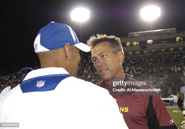 Coach Jim Zorn of the Washington Redskins meets coach Tony Dungy of the Indianapolis Colts after the Pro Football Hall of Fame Game at Fawcett...