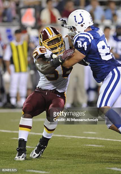 Linebacker Curtis Gatewood of the Washington Redskins battles against the block of tight end Jacob Tamme of the Indianapolis Colts in the Pro...