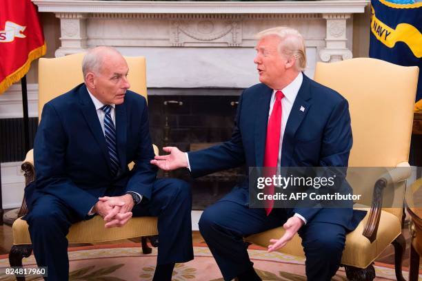 President Donald Trump speaks with newly sworn-in White House Chief of Staff John Kelly at the White House in Washington, DC, on July 31, 2017. US...