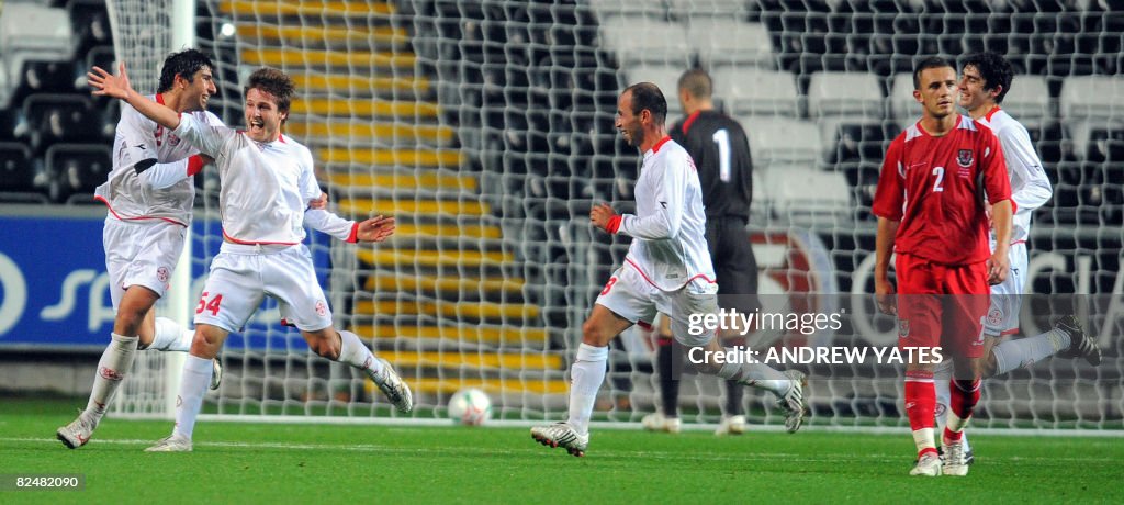 Georgia's Beka Gotsiridze (2L) celebrate