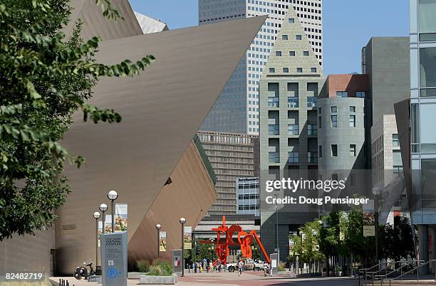 People walk past the Civic Center Cultural Complex which houses the Denver Art Museum, the Denver Public Library, the Colorado History Museum and the...