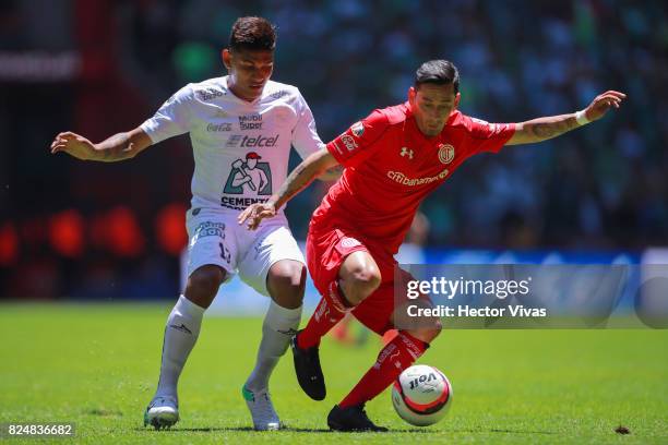 Alexander Mejia of Leon struggles for the ball with Rubens Sambueza of Toluca during the 2nd round match between Toluca and Leon as part of the...