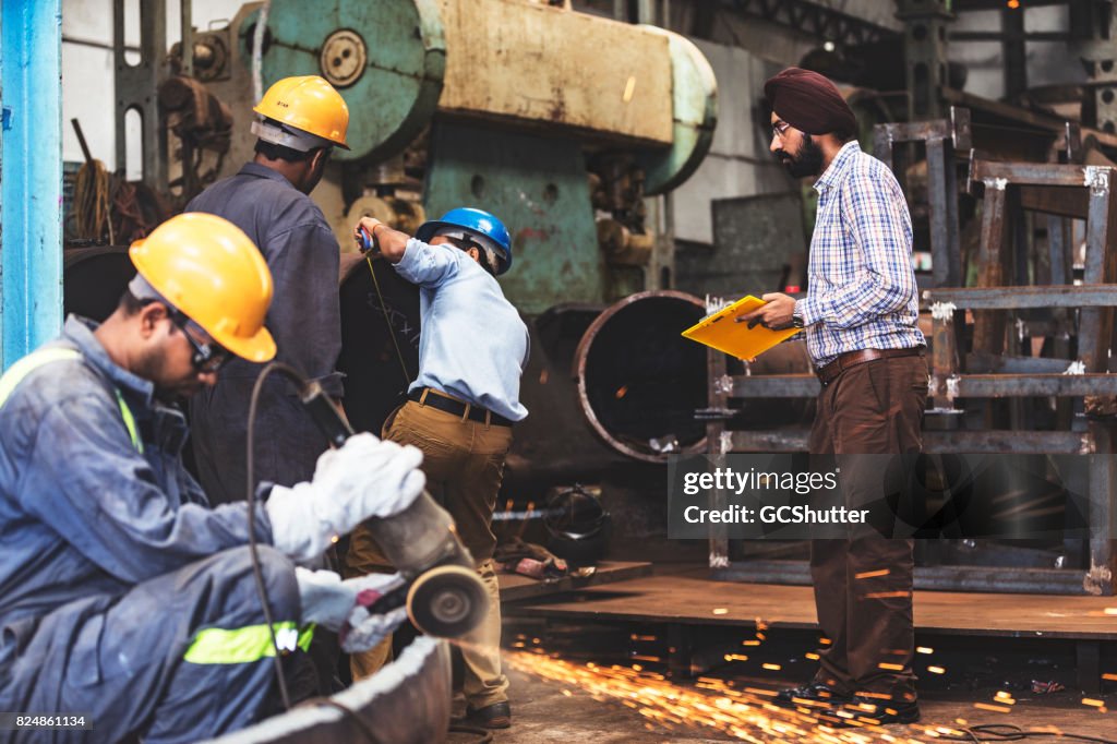 Factory supervisor monitoring the progress of several projects