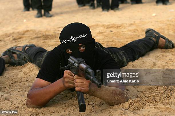 Palestinian fighters of the Hamas-affiliated Popular Resistance Committees participate during a military graduation ceremony on August 20, 2008 at...