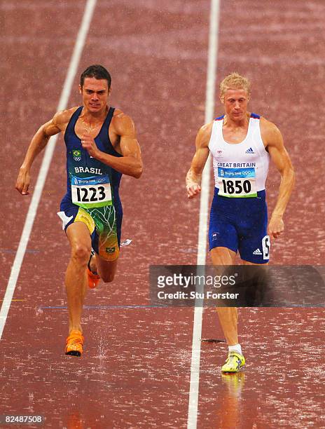 Carlos Chinin of Brazil and Daniel Awde of Great Britain compete in the Men's Decathlon 100m Final held at the National Stadium during Day 13 of the...
