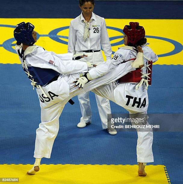 Diana Lopez of the US fighst with Chonnapas Premwaew of Thailand in the women's -57 kg taekwondo match at the 2008 Beijing Olympic Games on August...