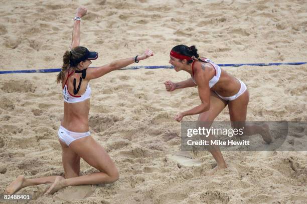 Kerri Walsh and Misty May-Treanor of the United States celebrate winning match point against Wang Jie and Tian Jia of China in the women's beach...