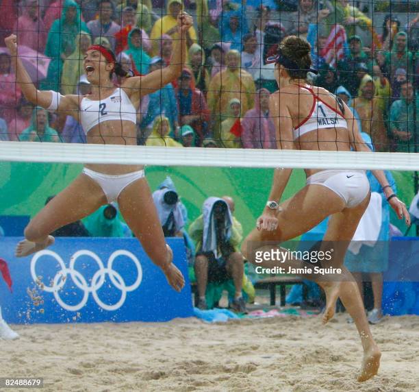 Misty May-Treanor and Kerri Walsh of the United States celebrate winning match point against Wang Jie and Tian Jia of China in the women's beach...